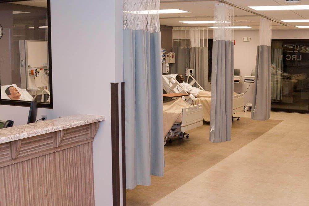 View looking down hallway of "Bearcat Hospital" with multiple mannequins in hospital beds