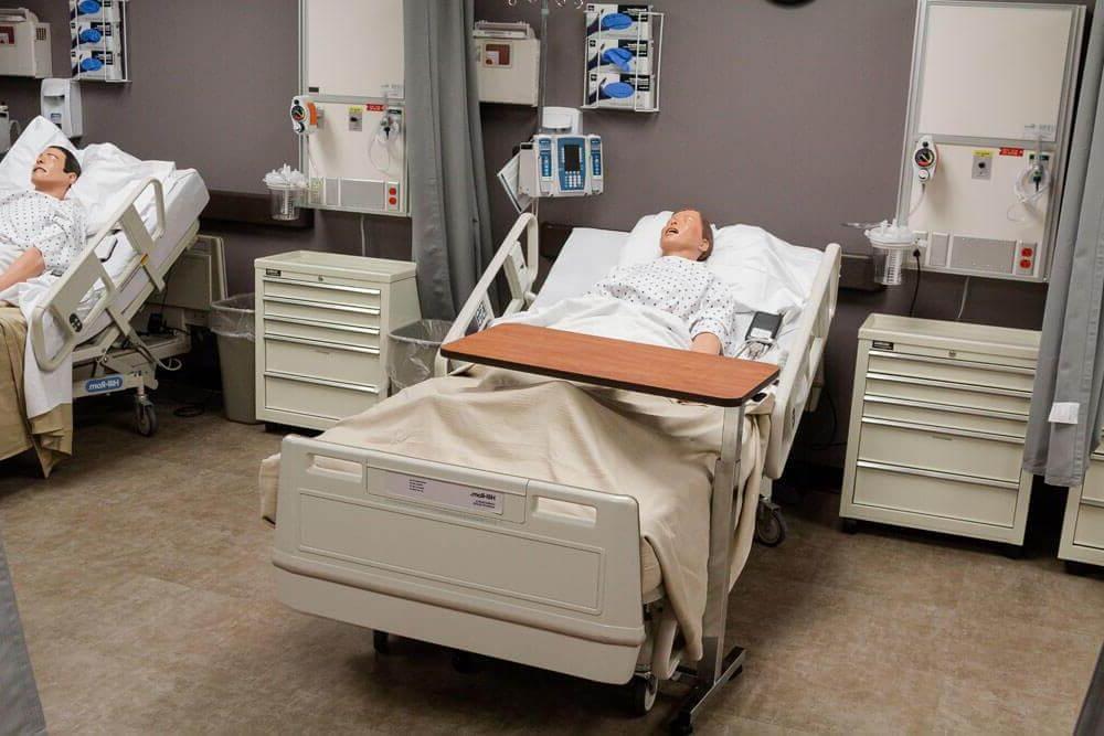 Two mannequins in hospital beds