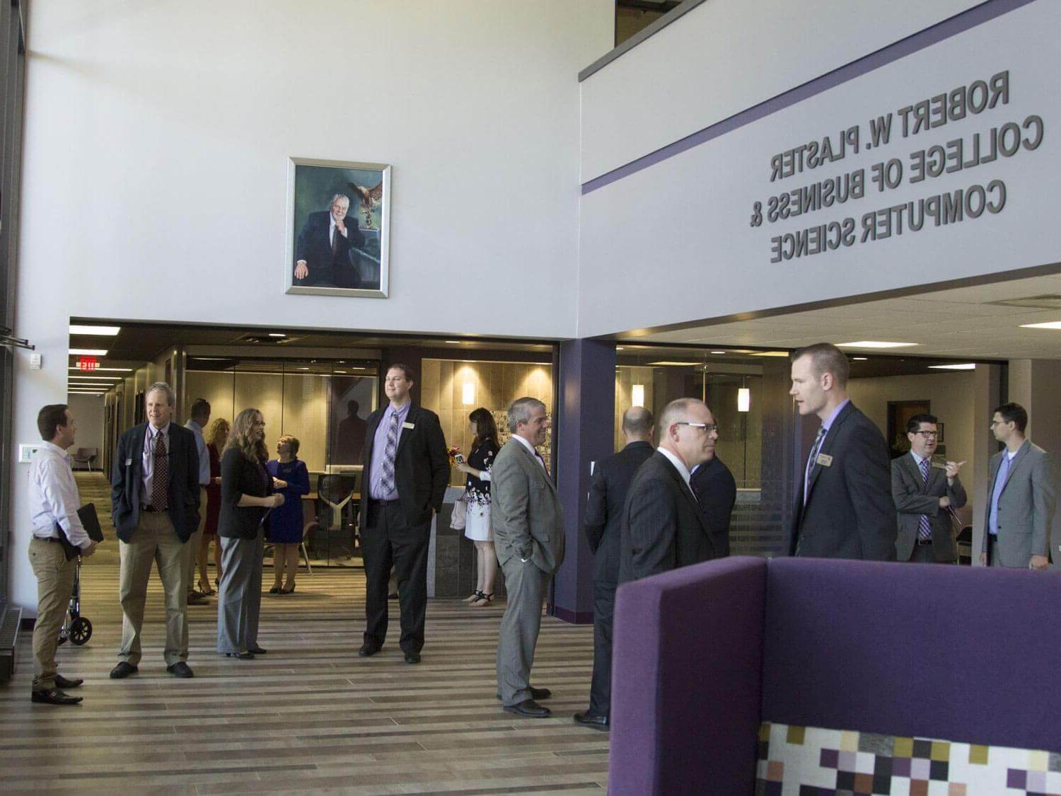 businesspeople mingle in building lobby