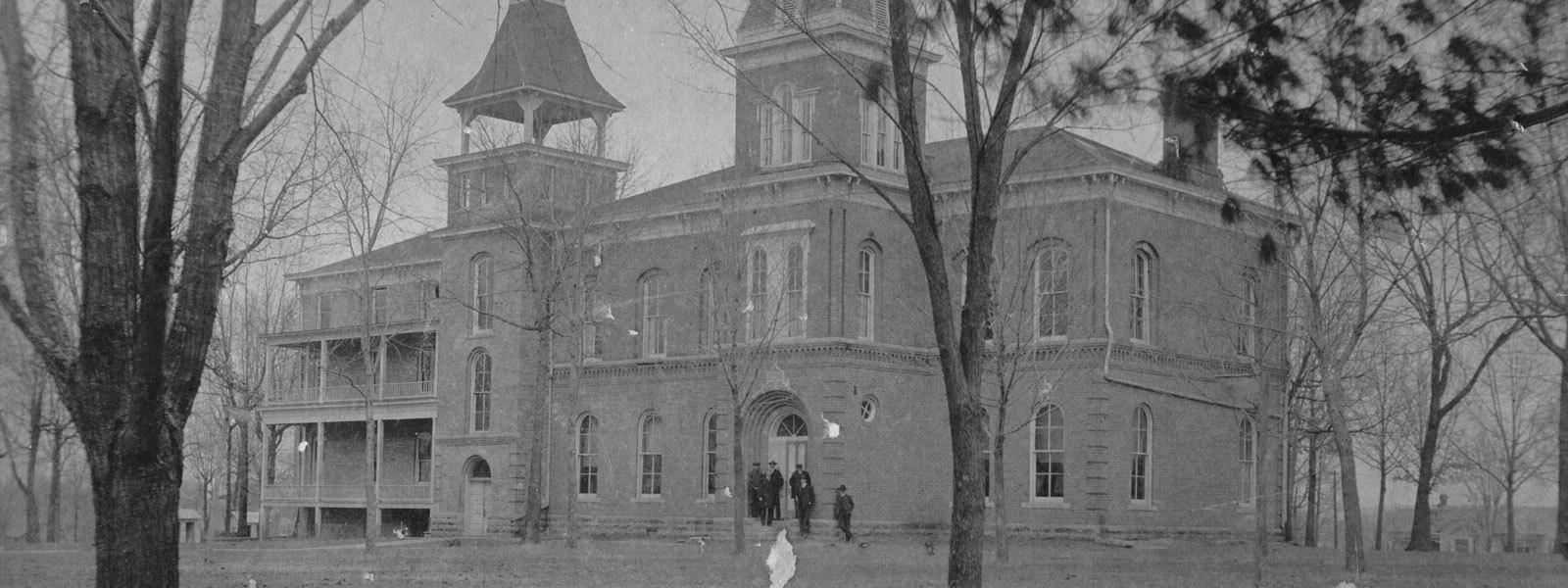 black and white photo of original campus building