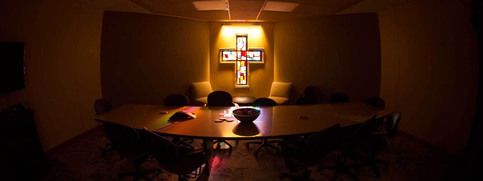 stained glass cross window in conference room