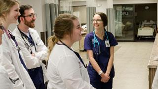 students talk and smile in nursing training center