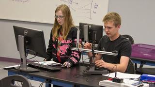 two students working on physics project