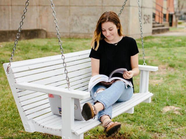 Female student reading outside