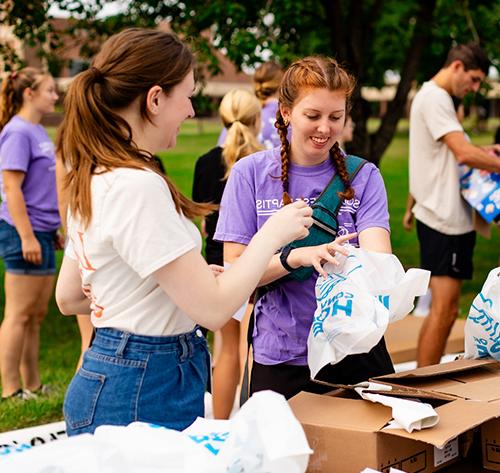 students leading a food drive on campus